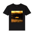 t-shirt with a graphic of a big cat walking in a field at sunset on a scorched foreign plain